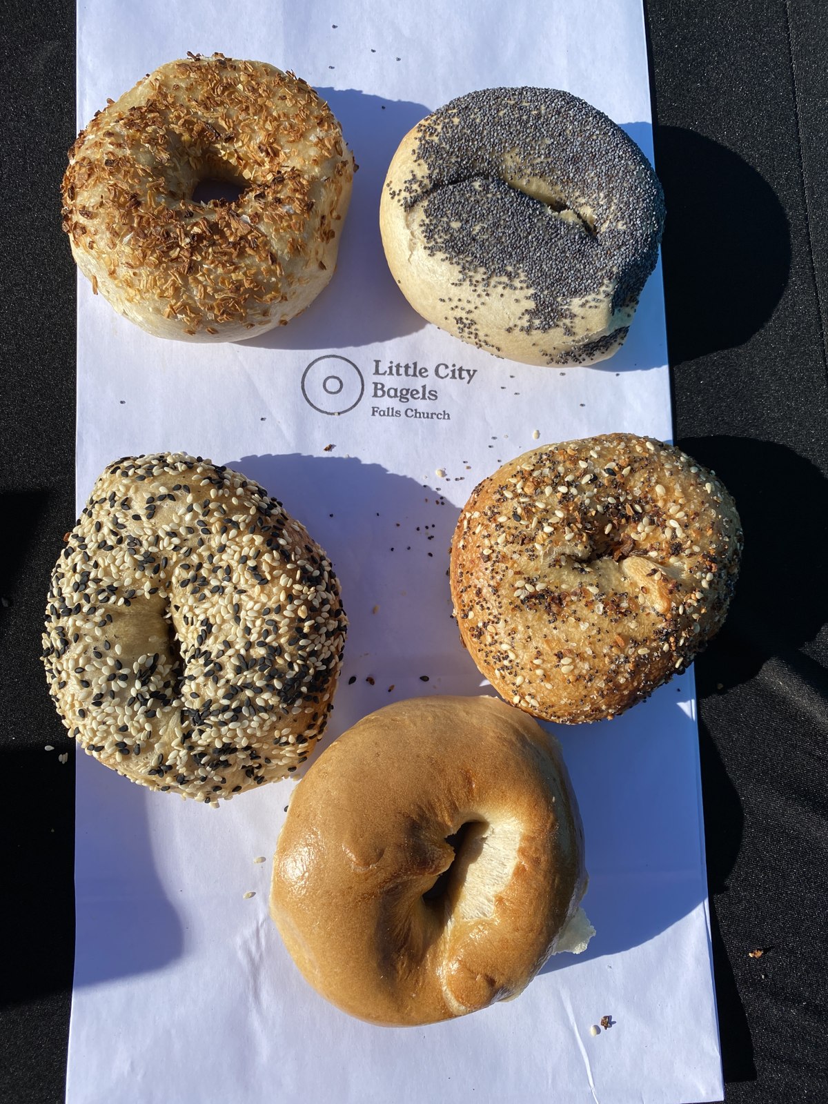 An assortment of plain, seeded, and everything bagels at the Little City Bagels stand